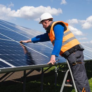 solar-power-plant-worker-on-stepladder-makes-a-visual-inspection-of-solar-panels.jpg
